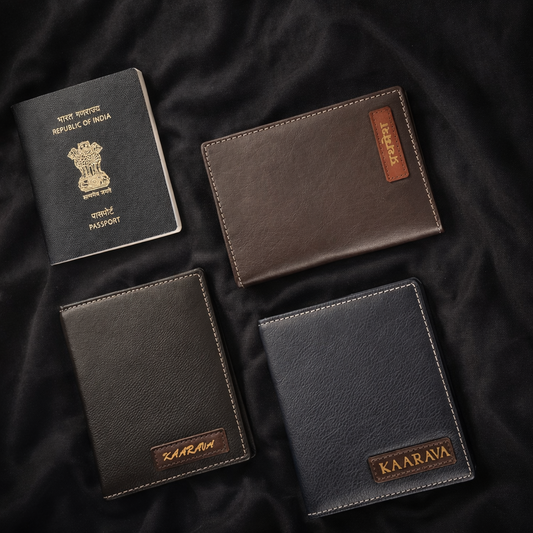 Four leather wallets in different colors on a dark fabric background